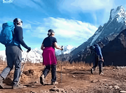 Trekker walking along snow-covered Mardi Himal trail with Machhapuchhre (Fishtail) in the background