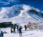 Trekker enjoying Annapurna mountain view at snowy Thorong La Pass