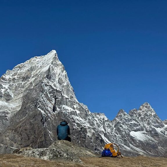 Hikers watching Mount Everest and surrounding peaks from Everest Base Camp trail in Nepa
