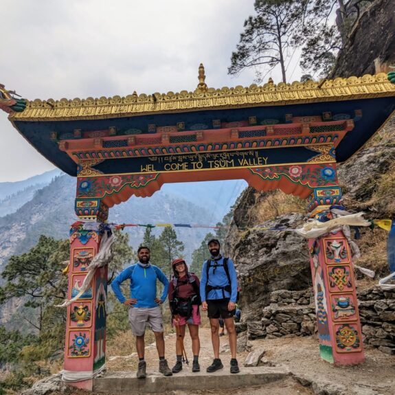 Trekkers standing at the main gate of Tsum Valley during the scenic Tsum Valley Trek in Nepal