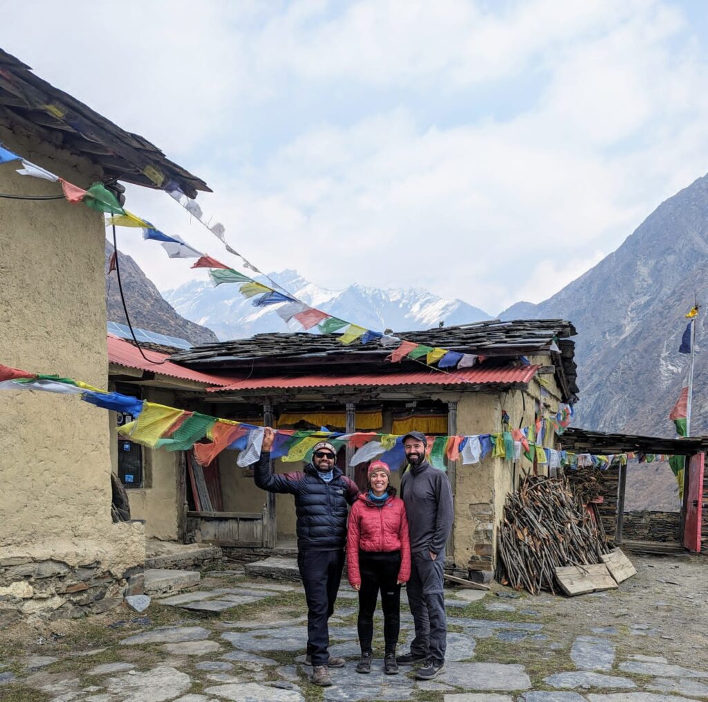 Trekkers enjoying the scenic trails of Tsum Valley in the Manaslu Circuit Trek, surrounded by Himalayan mountains and traditional villages