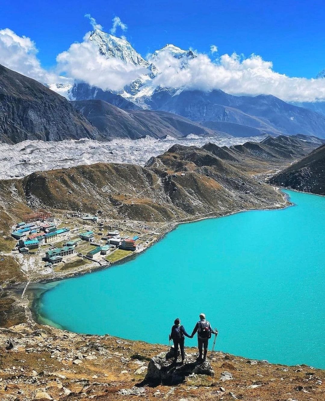 Panoramic view of Gokyo Lakes surrounded by snow-capped Everest region mountains during spring trek